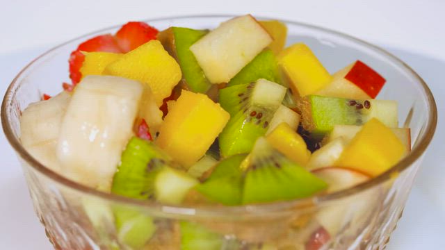 Rotating bowl with fruit on a white background.