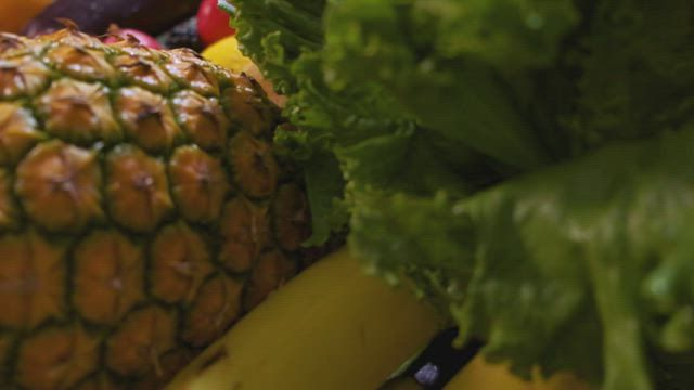 Surface covered with many fruits and vegetables seen in detail.