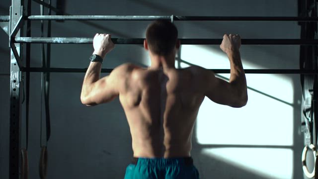 Man training on the bars in the gym.