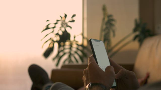 A guy texting on his smartphone .