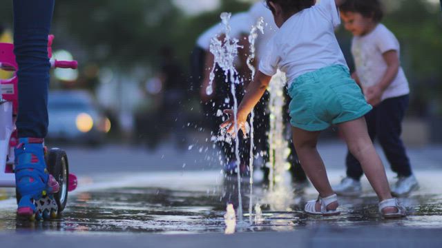 Children playing with a dancing fountain.