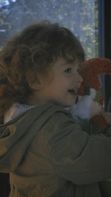 Happy and funny girl with a stuffed Santa Claus.