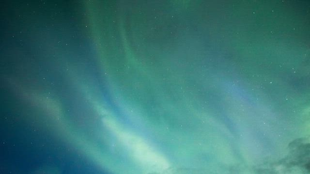 Northern Lights of blue and green colors in the night sky.