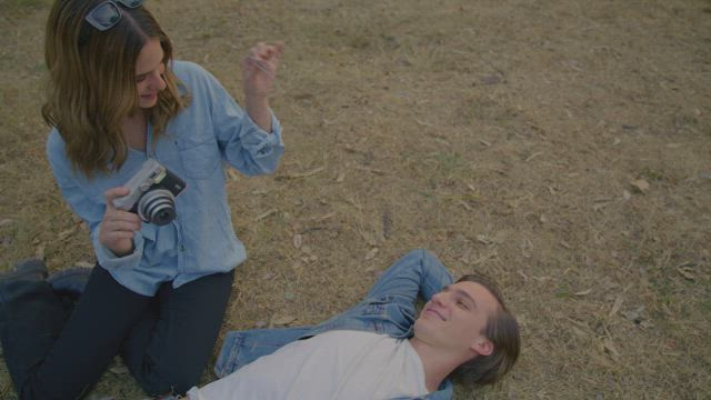 Couple having fun with a polaroid camera.