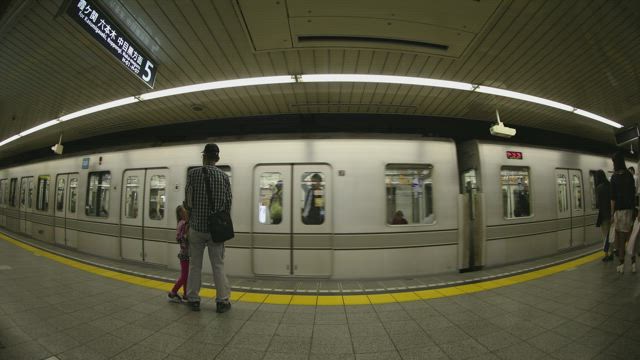 Fisheye lens shot of the subway arriving.