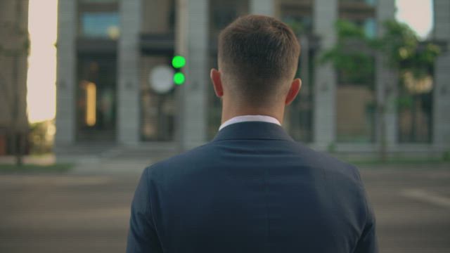 Man dressed in suit crossing the street.