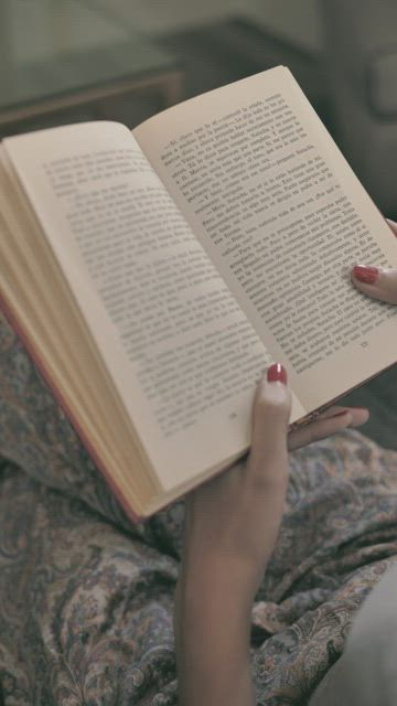 Woman sitting reading in pajamas.